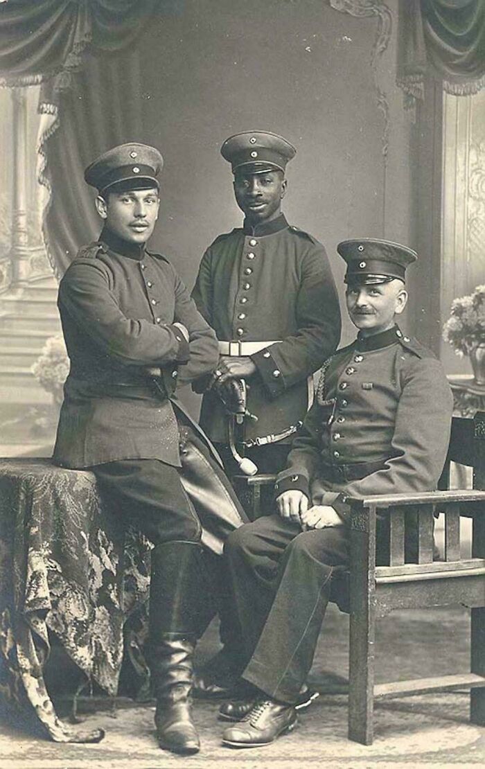 Three men in military uniforms posing for historical photos, showcasing the emotional past