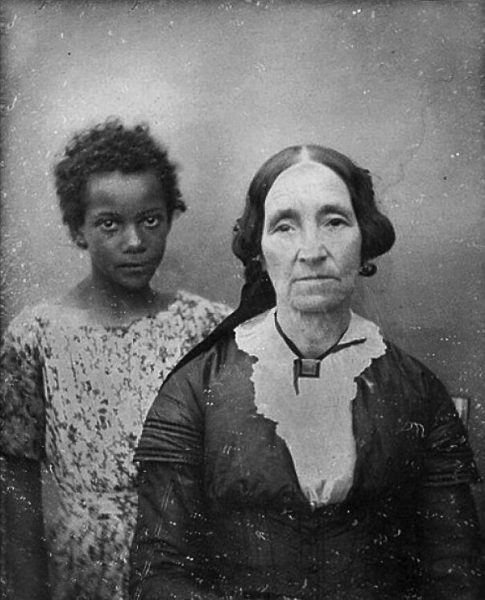 Black and white historical photos capturing a young boy standing behind an older woman, emotional past