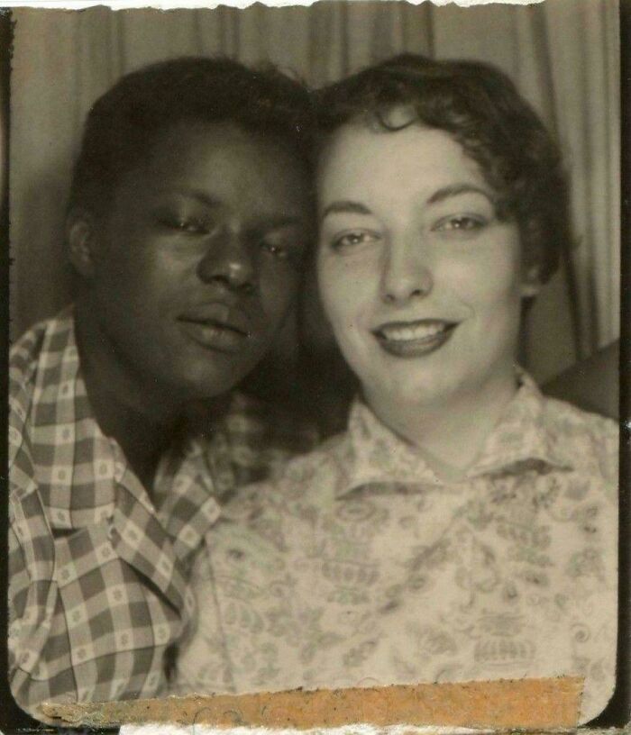 A black and a white woman smiling, posing for a photo. This is one of many fascinating historical photos.