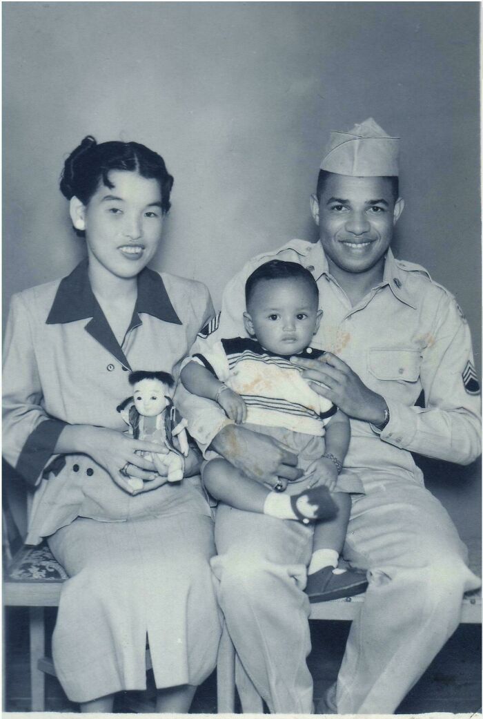 Emotional historical photos of a mixed-race couple in military uniform holding their baby and a doll, reflecting the past.