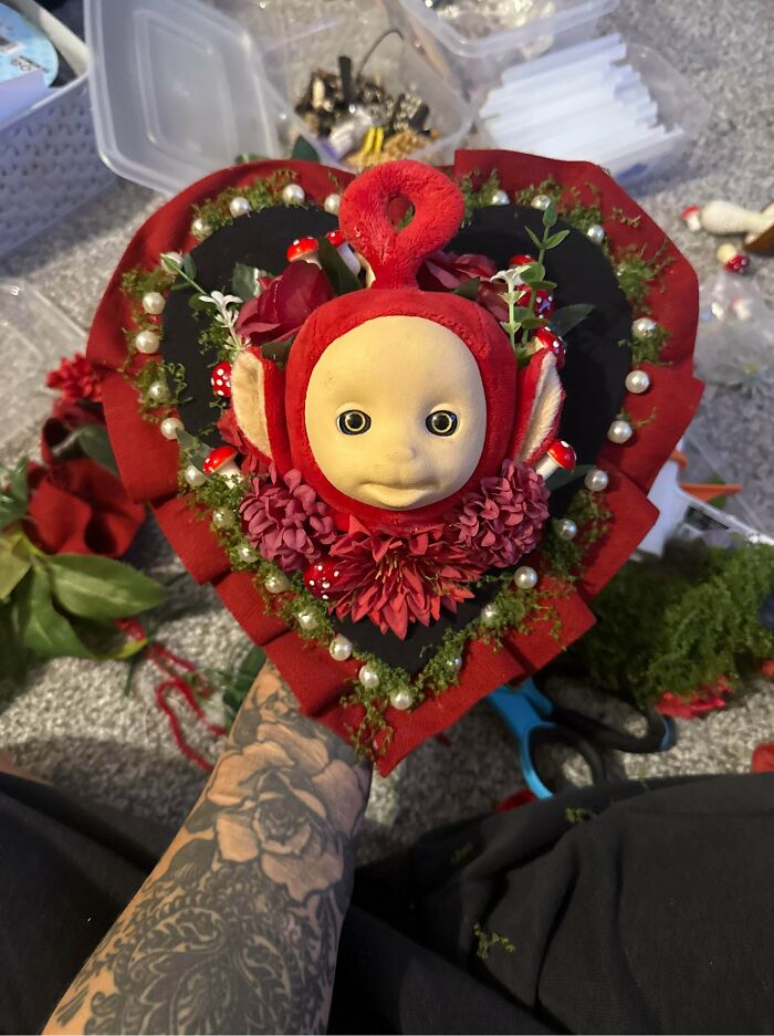 Strange Teletubbies character framed in flowers as part of questionable DIY projects.