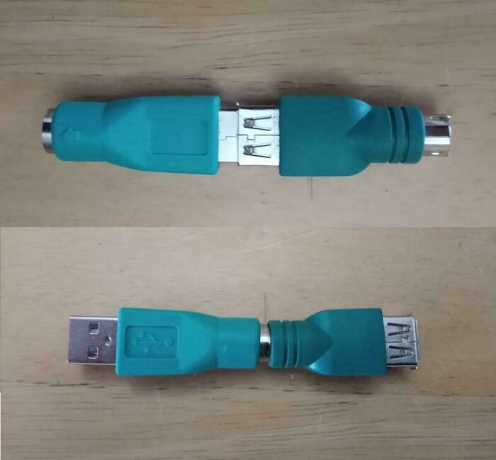Two teal adapter cables plugged into each other in a bizarre fashion, showcasing strange DIY projects.