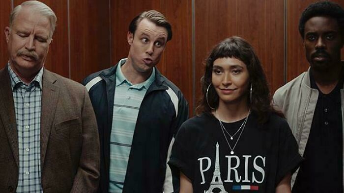 Four people in an elevator. A diverse group of dads, with varying expressions. Feel-good posts.