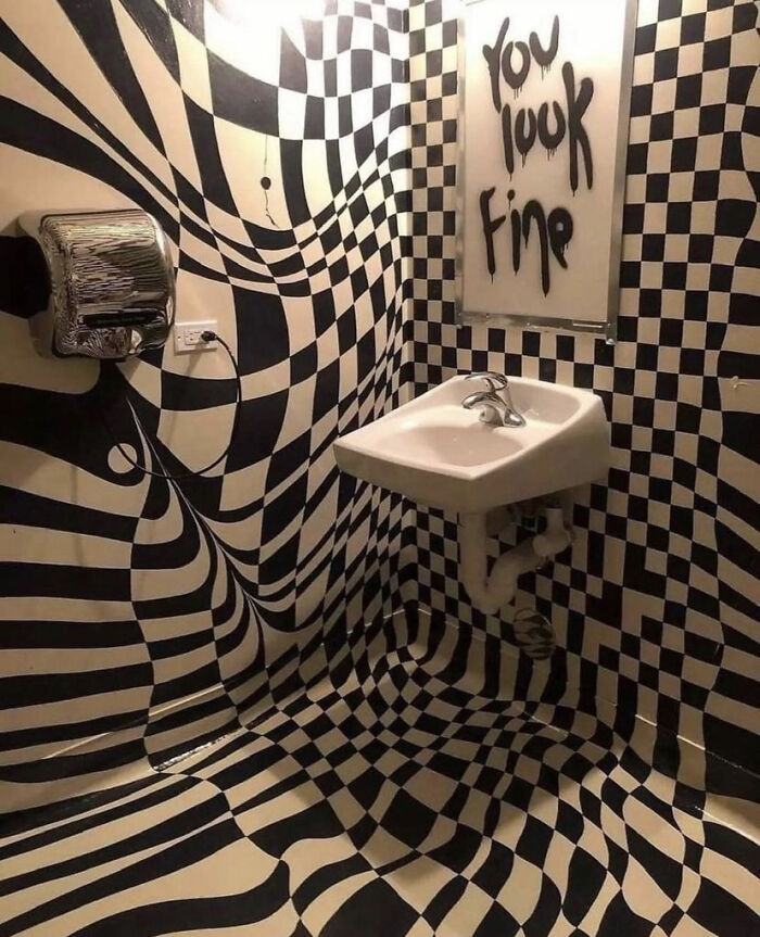 Black and white checkered bathroom with distorted patterns and sink