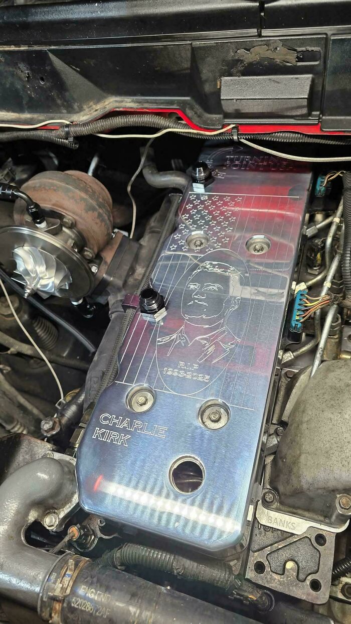 Car engine cover engraved with Charlie Kirk memorial art