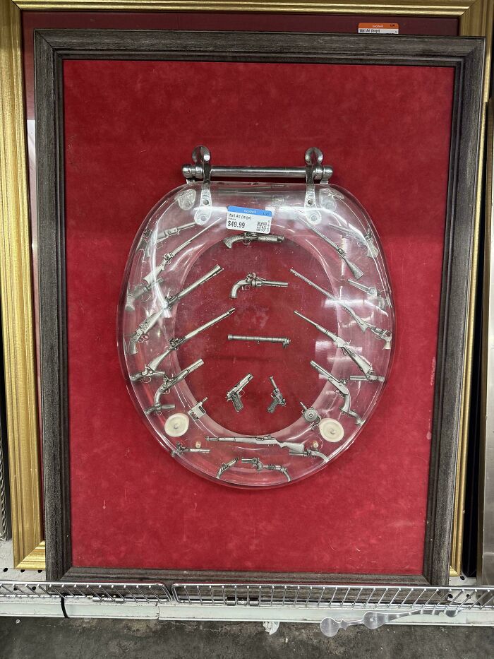 Toilet seat decorated with miniature gun replicas