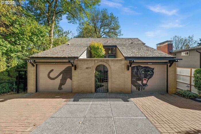 House with artistic black panther garage door murals
