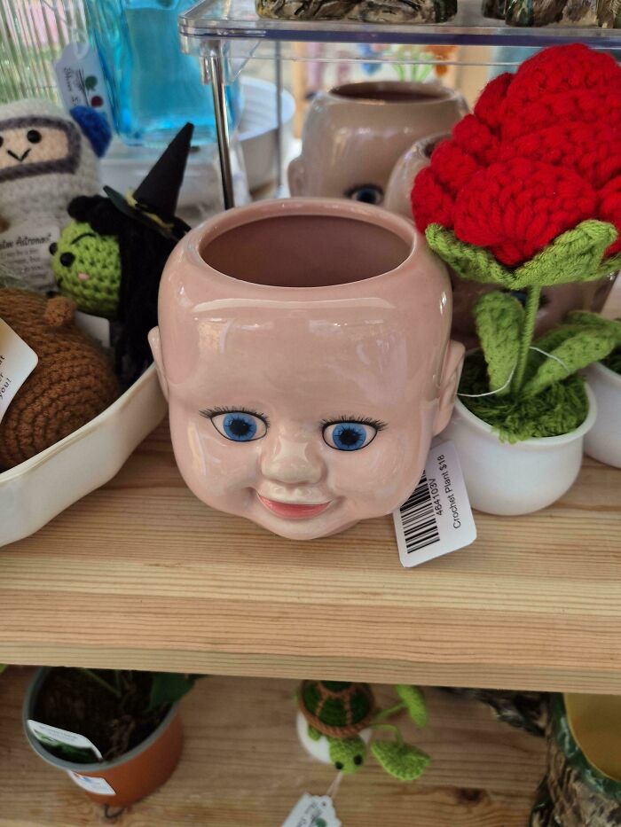 Creepy baby face planter flowerpot with large blue eyes