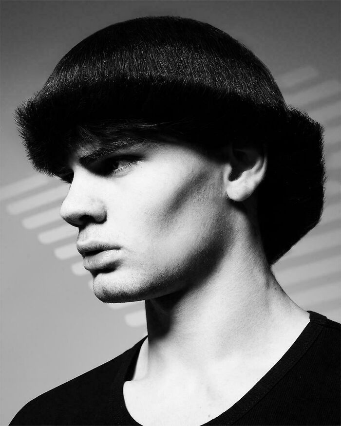 Black and white side profile of man with unusual sculpted haircut