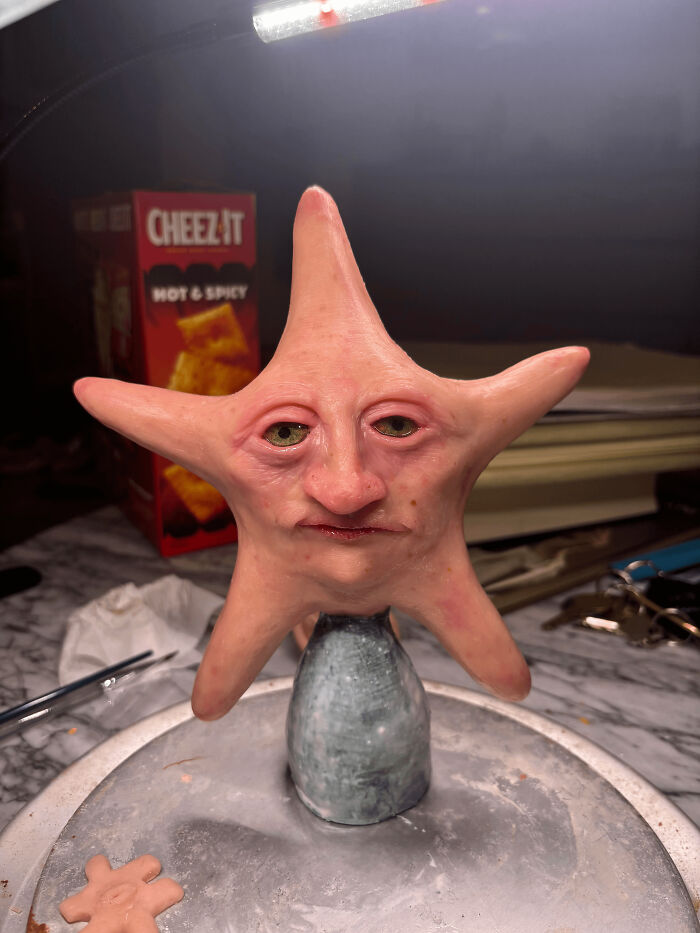 Starfish sculpture with a human-like face and eyes