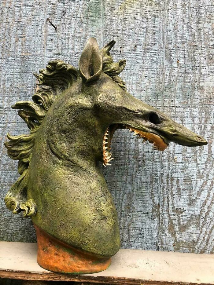 Unicorn sculpture with sharp teeth and detailed mane design