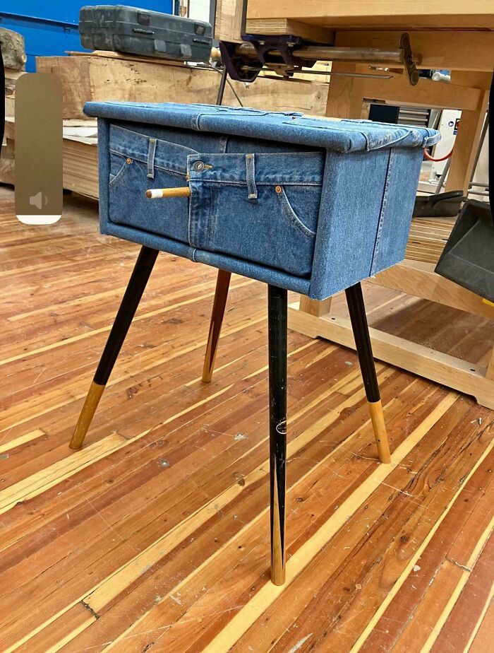 Unique side table covered in denim fabric with jean pockets