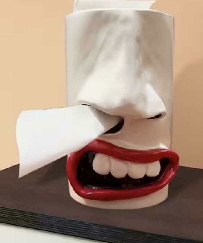 Tissue dispenser designed with exaggerated red lips and nose