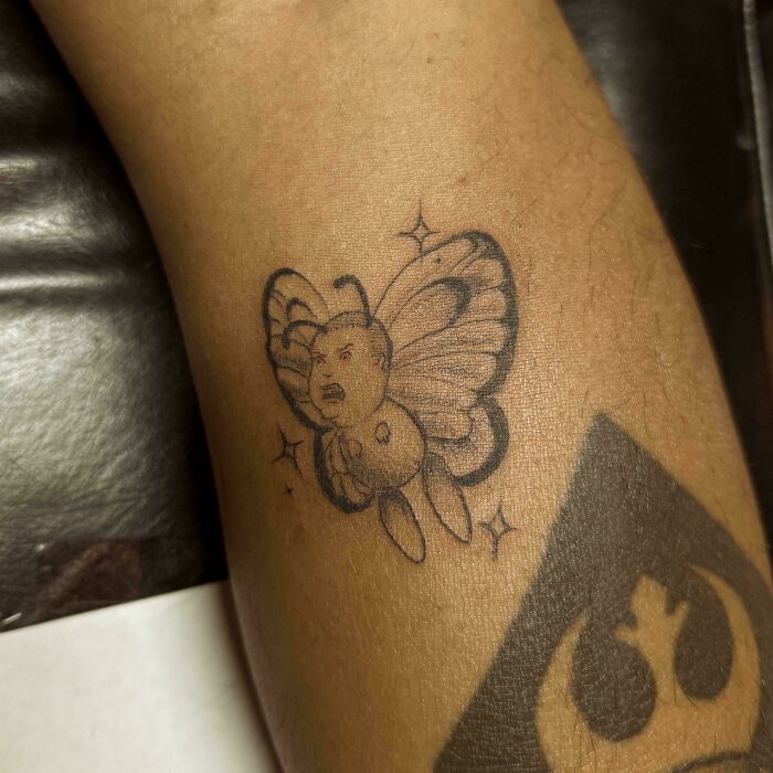 Tattoo of angry baby butterfly highlighting dubious skill application