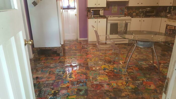 Kitchen floor decorated with comic book covers as flooring using creative skills