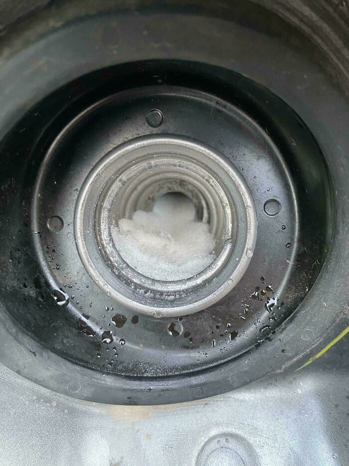 Car mechanics discover a white, powdery substance in a car's fuel tank, indicating unusual car problems.