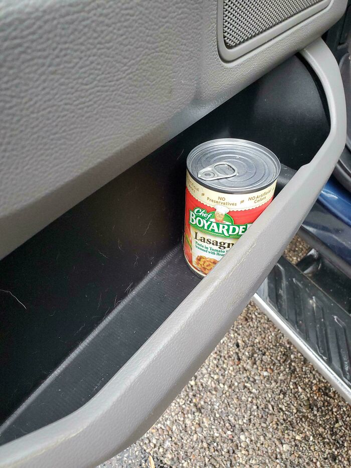 A can of Chef Boyardee Lasagna in a car door pocket, a sight car mechanics capture to show unusual situations.