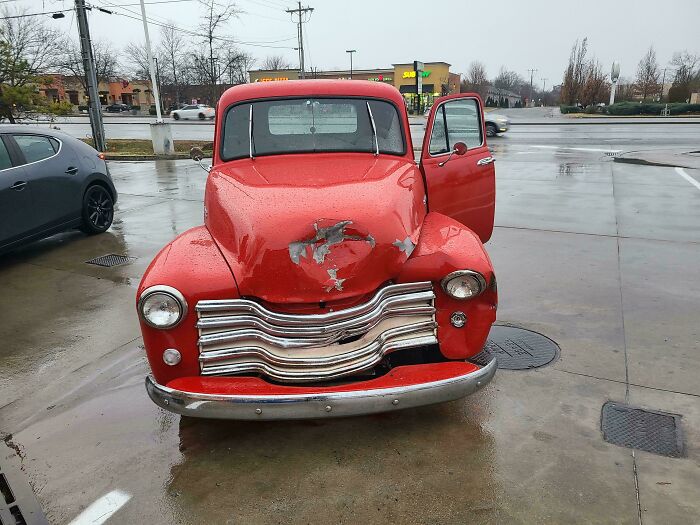 A red pickup truck with significant front-end damage, showcasing what car mechanics deal with.
