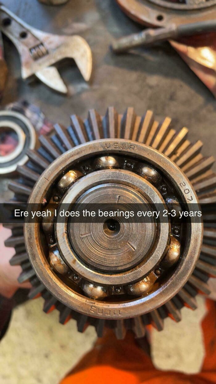 A close-up of a ball bearing assembly with a gear, indicating a complex car mechanics repair.