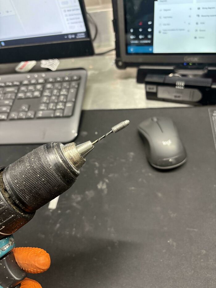 A drill with a stripped s***w in its chuck, a common issue car mechanics deal with.