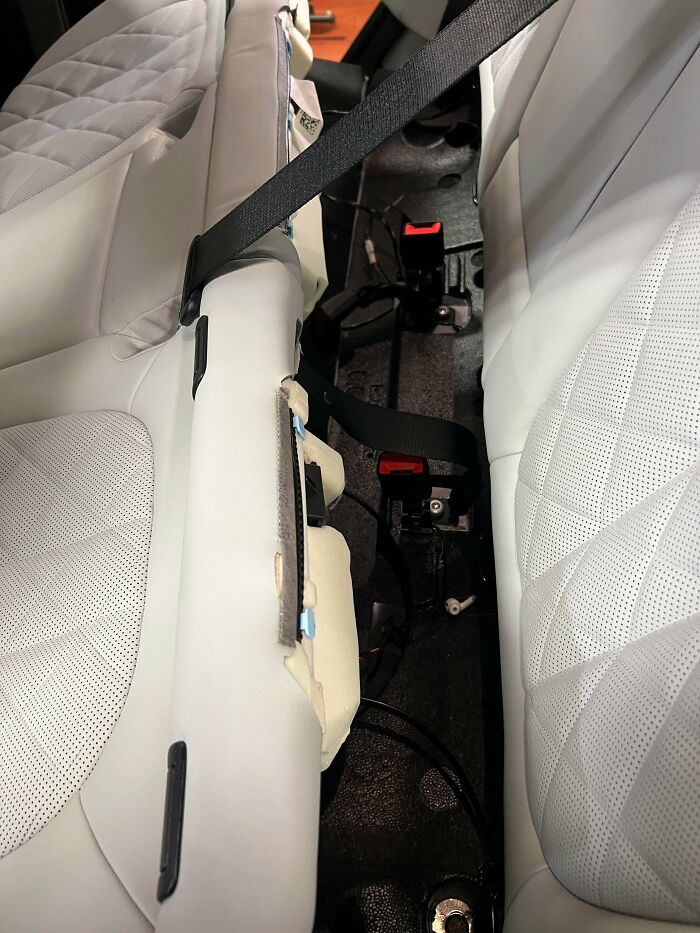 The interior of a car with a seat removed, revealing the inner workings, a detailed view for car mechanics.