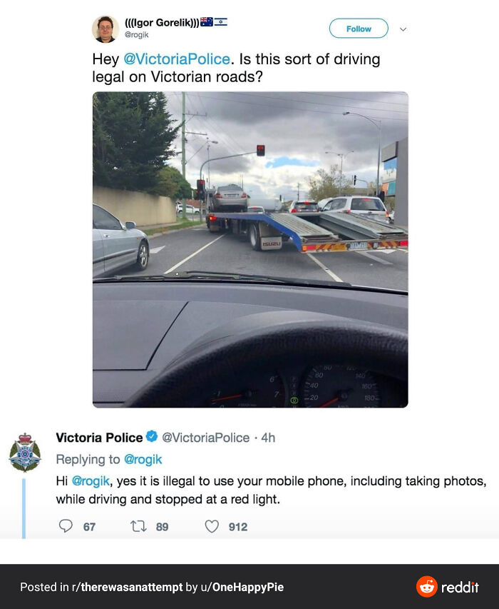 Car being towed on a flatbed truck at a red light, illustrating funny regret moments and bad decisions while driving.