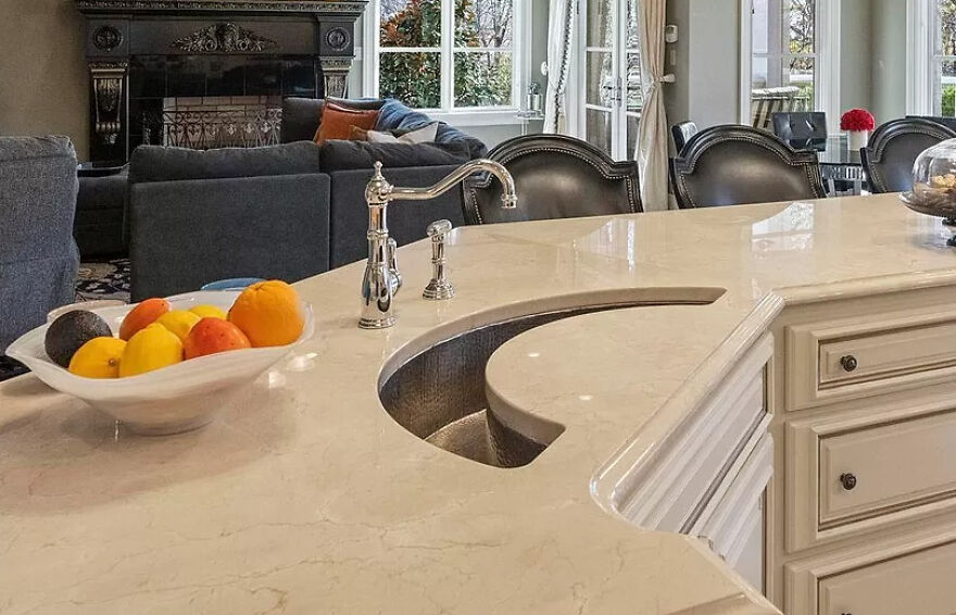 Kitchen countertop with a curved sink design making usability difficult, showcasing design gone too far.