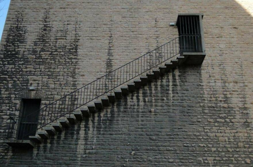 Outdoor staircase design gone wrong with unreachable door, an example of designers going too far and making things impossible to use.