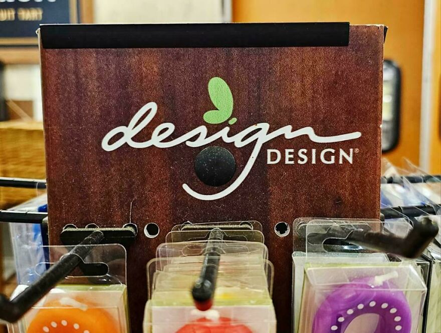 Packaging for plastic items on a display rack showing poor design with hooks making items impossible to use or access.