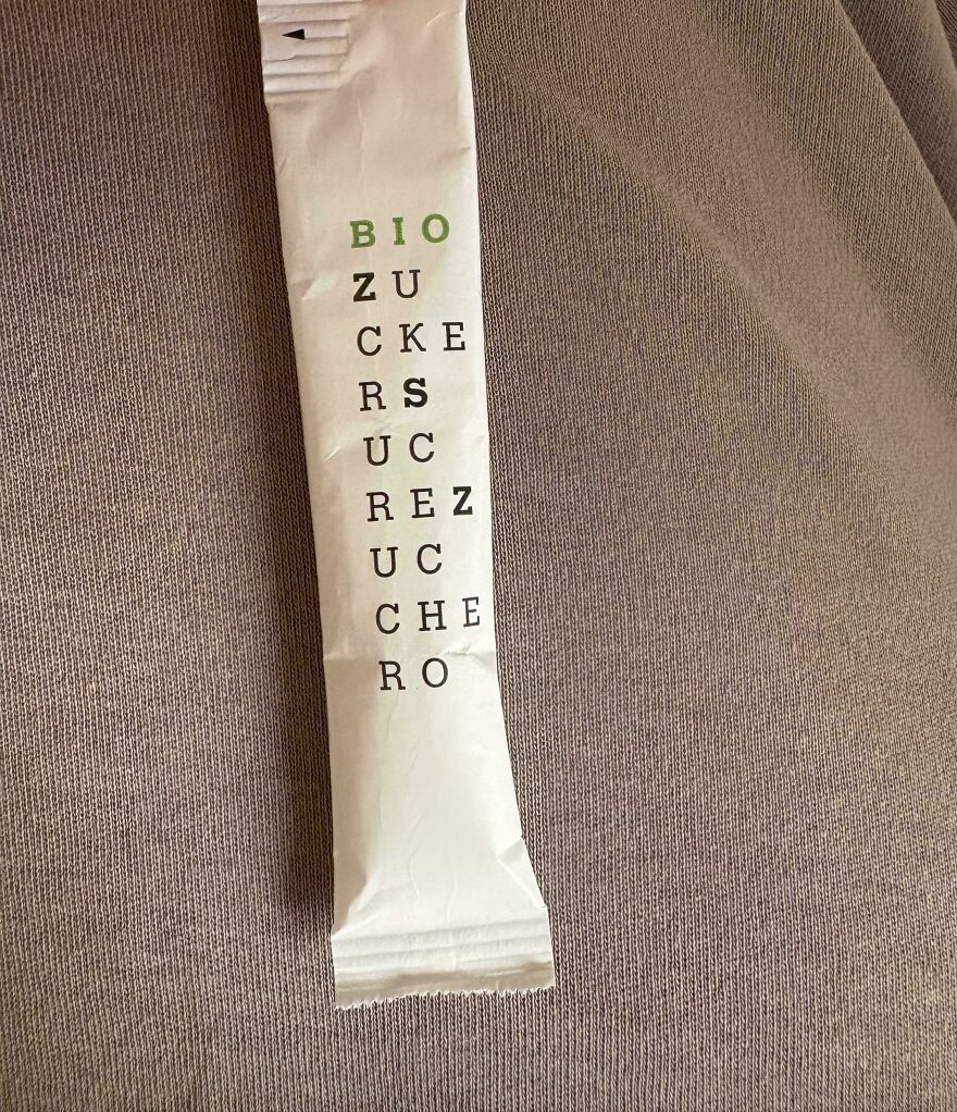 Sugar packet with confusing vertical text design, an example of designers going too far and making things impossible to use.