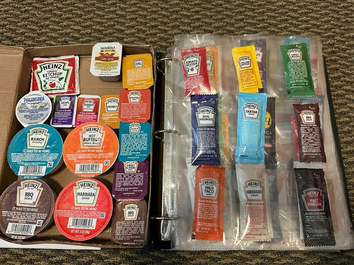 Collection of various Heinz sauce packets organized in a binder, showcasing a unique obsession and collection hobby.