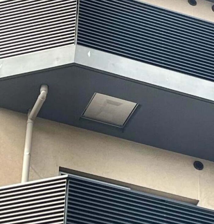Balcony with a hidden floor hatch cleverly concealed by a vent panel, a genius idea to solve an annoying problem.