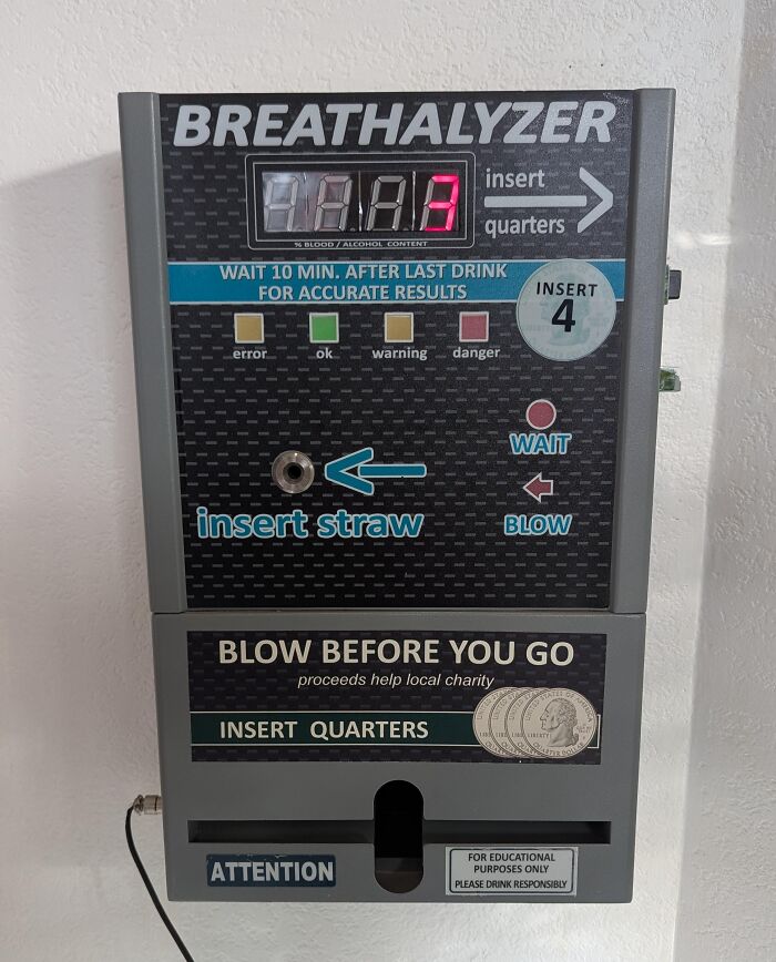 Wall-mounted breathalyzer with instructions to insert quarters and straw, an example of genius problem-solving ideas.
