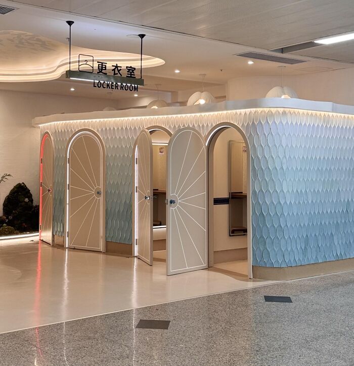 Modern locker room design with multiple arched doors solving space use challenges with a surprisingly genius idea.