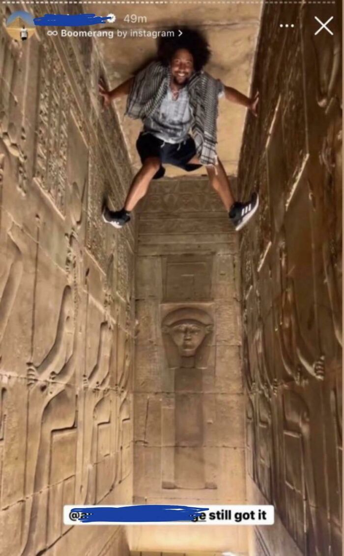 Man humorously caught between ancient temple walls, showcasing unexpected talent in a 1% brain capacity moment.