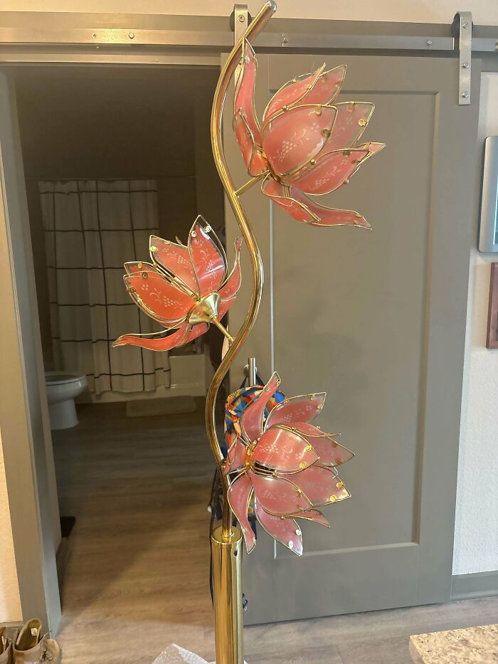 A unique floor lamp with three pink, lotus-shaped lights, found as a thrift store jackpot.