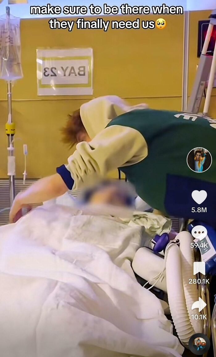 Influencer leaning over a hospital bed with medical equipment, captured in a moment defying common sense rules.