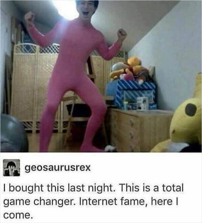 Person in a pink bodysuit posing excitedly in a room filled with toys, a weird and cringey photo.