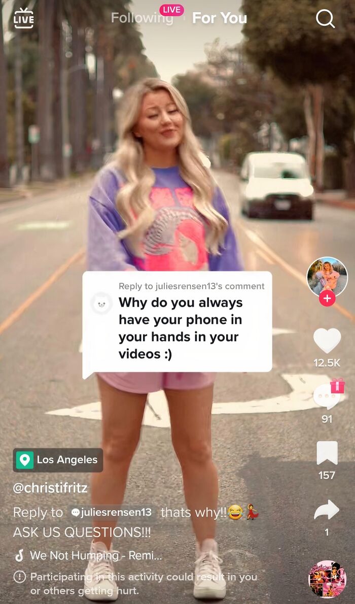 Blonde influencer standing in the street holding a phone, illustrating cringy influencers defying common rules.