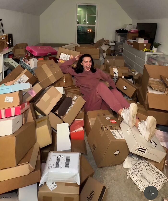 Person lounging amidst a huge pile of cardboard boxes, illustrating cringy influencers ignoring rules and common sense.
