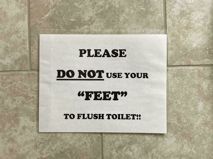 Sign with suspiciously placed quotation marks around the word feet, humorously warning against using them to flush toilet.