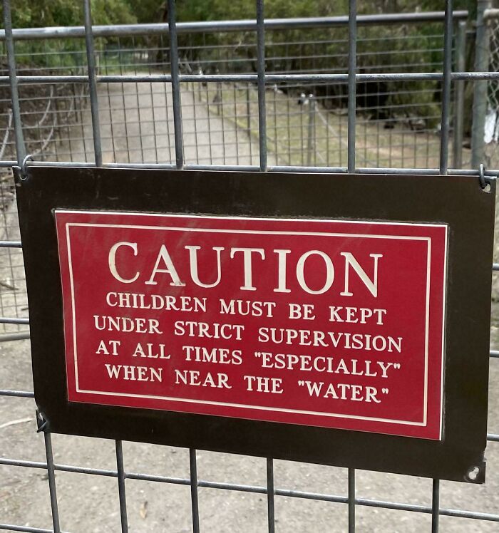 Red caution sign with quotation marks around words, making the warning sound hilariously suspicious and unusual.