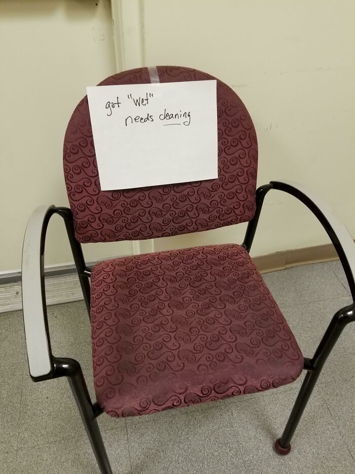 Chair with a handwritten sign using quotation marks around the word wet, making the cleaning note sound suspicious.