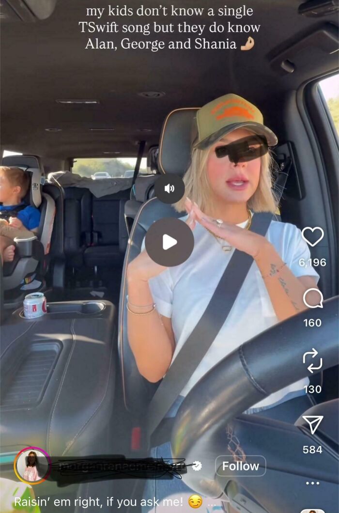 Influencer driving while talking in car with child in car seat, showing cringy behavior ignoring common sense rules.