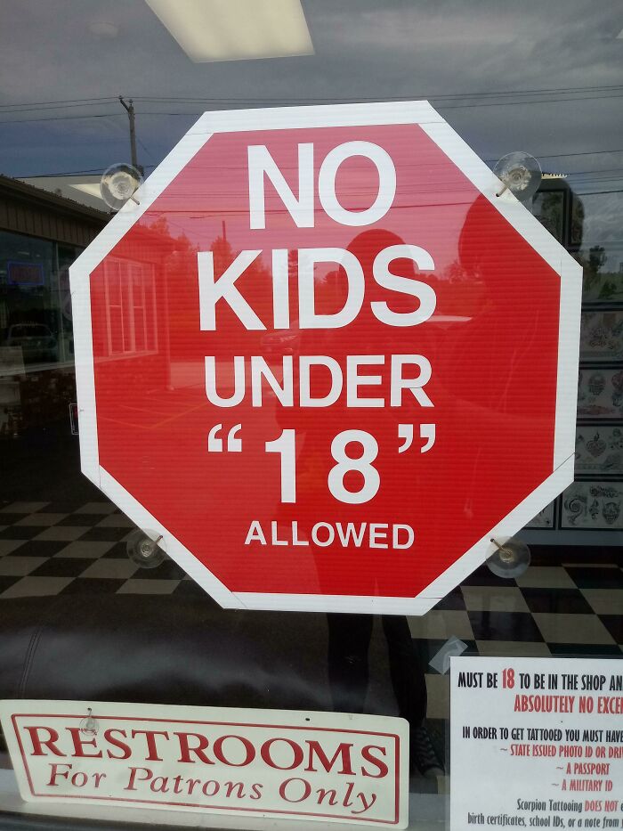 Stop sign with quotation marks around 18, creating a hilariously suspicious message about age restrictions.