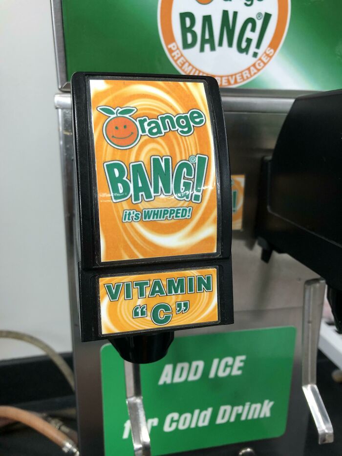 Orange BANG soda dispenser with a sign putting suspicious quotation marks around Vitamin C.