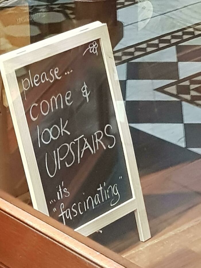 Chalkboard sign with suspicious quotation marks around the word fascinating, making everything sound hilariously suspicious.