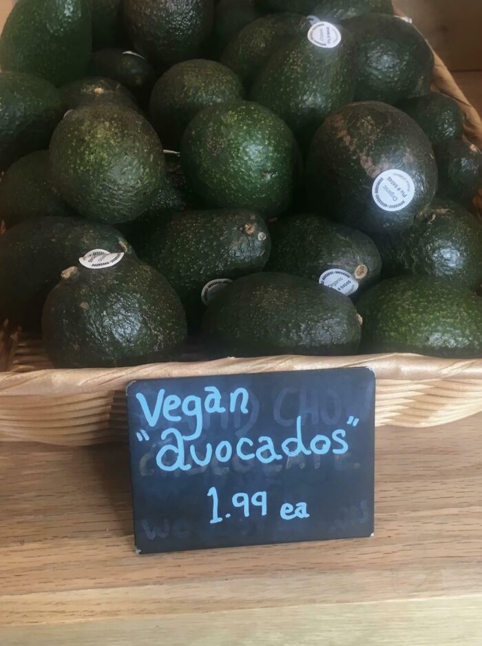 Basket of avocados with a price sign hilariously placing suspicious quotation marks around "avocados" phrase.