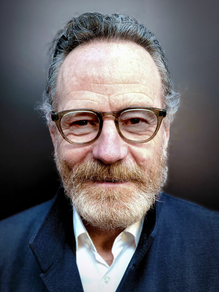 Bryan Cranston close-up portrait wearing glasses and a dark jacket, highlighting his bio and career highlights.