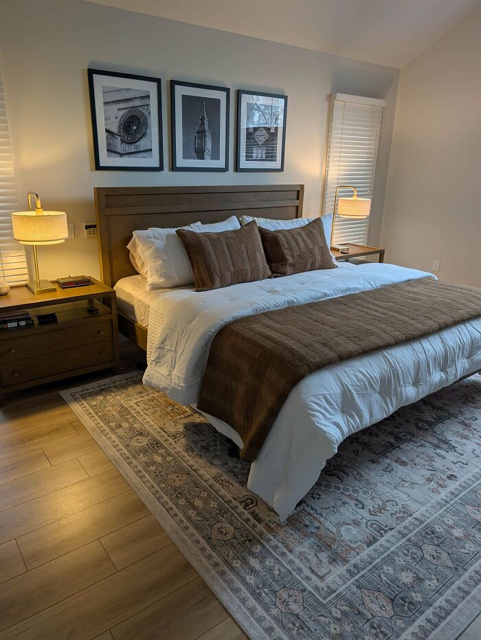A beautifully organized bedroom with a large bed, wooden furniture, and framed art, displaying a lovely home decor project.